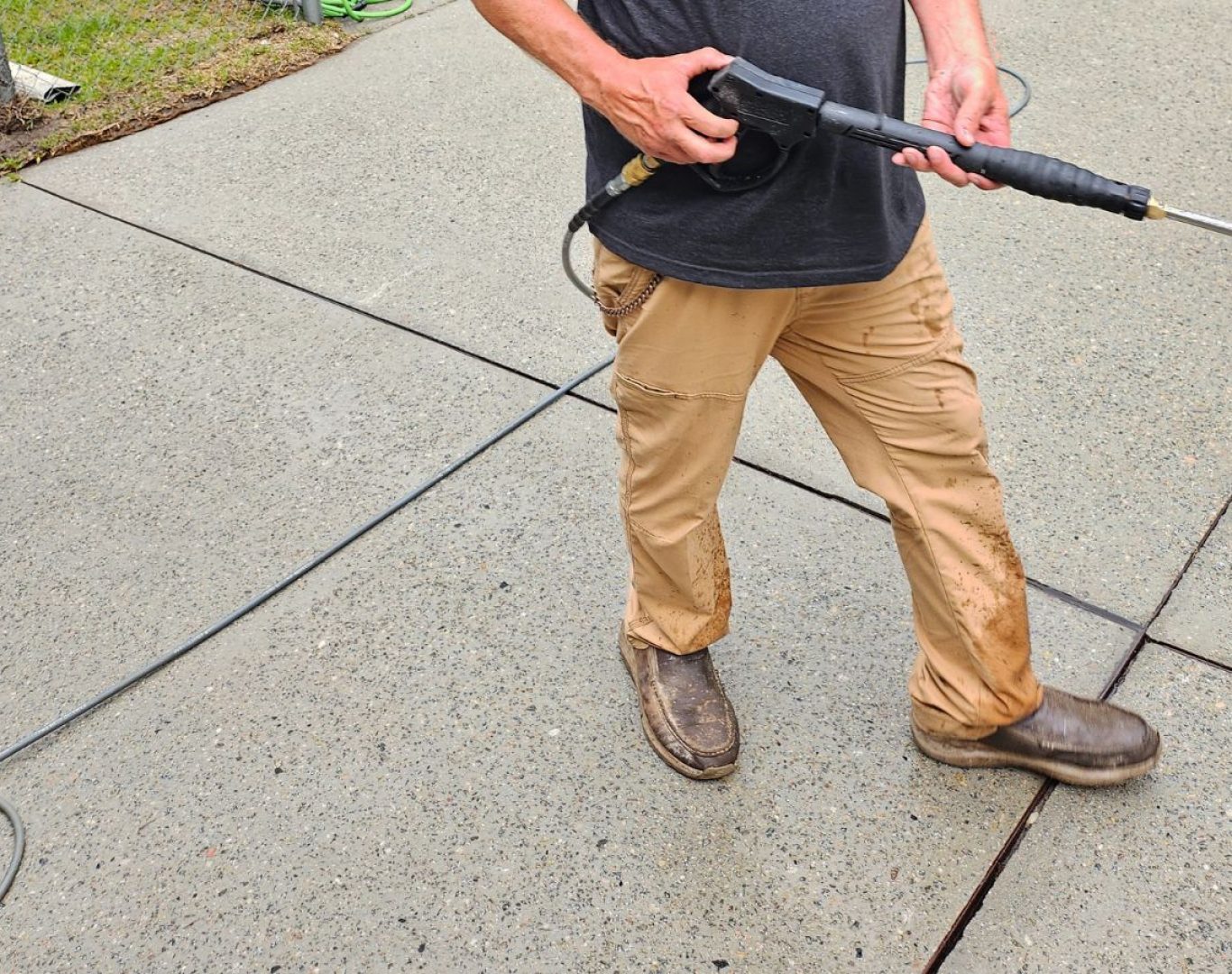 A The Scrub Buddies team member delivering pressure washing in Supply, NC, demonstrating improved cleanliness and surface protection for residential properties.